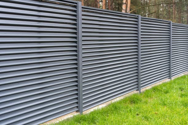Dark horizontal slat fence beside a lawn