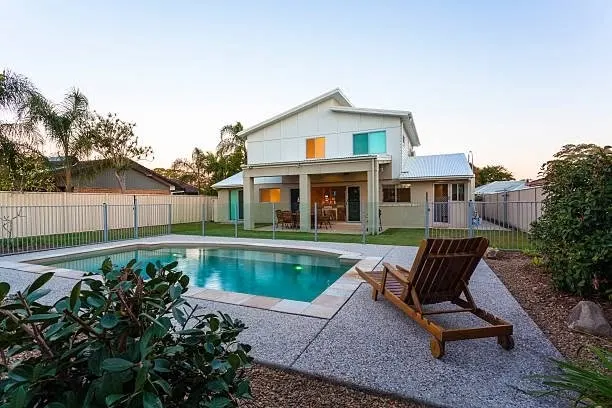 Residential swimming pool enclosed by metal pool fencing