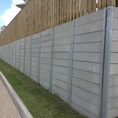 Long concrete sleeper retaining wall beneath a timber fence